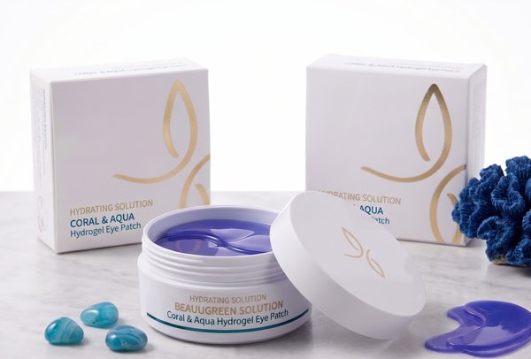 Cosmetic product with packaging and blue gel pads on a white surface