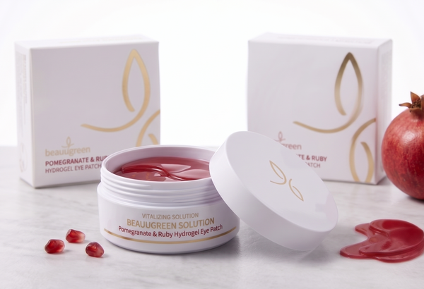 Cosmetic products with pomegranate elements on a white background