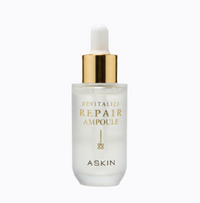 Repair ampoule bottle with gold cap on a white background