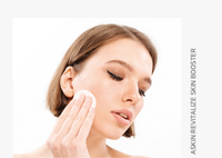 Woman applying a skincare product on her face with a white background
