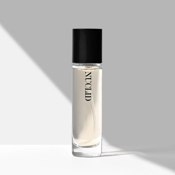 Clear bottle with black cap labeled 'NUCLID' on a gray background