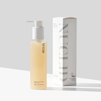Skincare bottle with pump and packaging on a light gray background